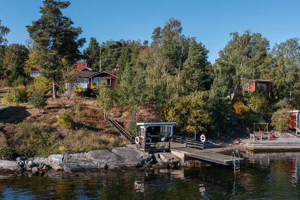 Underbar strandlinje med klippor och strand intill bryggdäcket